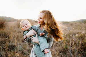 Austin Family Photographer, mother smiling and swinging child through the air