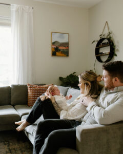 mother holding newborn during indoor newborn photos