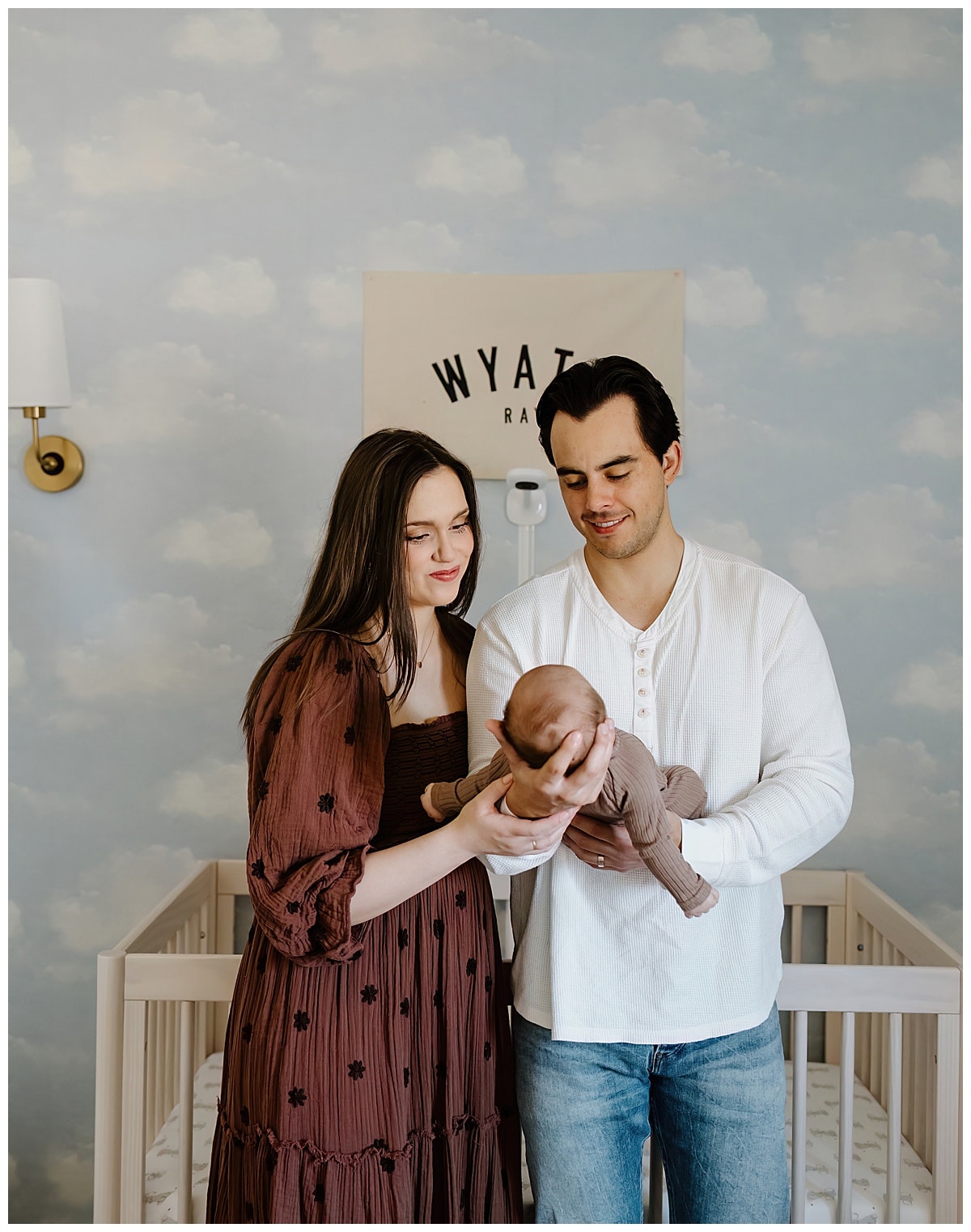 After Preparing For Your Newborn Storytelling Session parents smile at baby