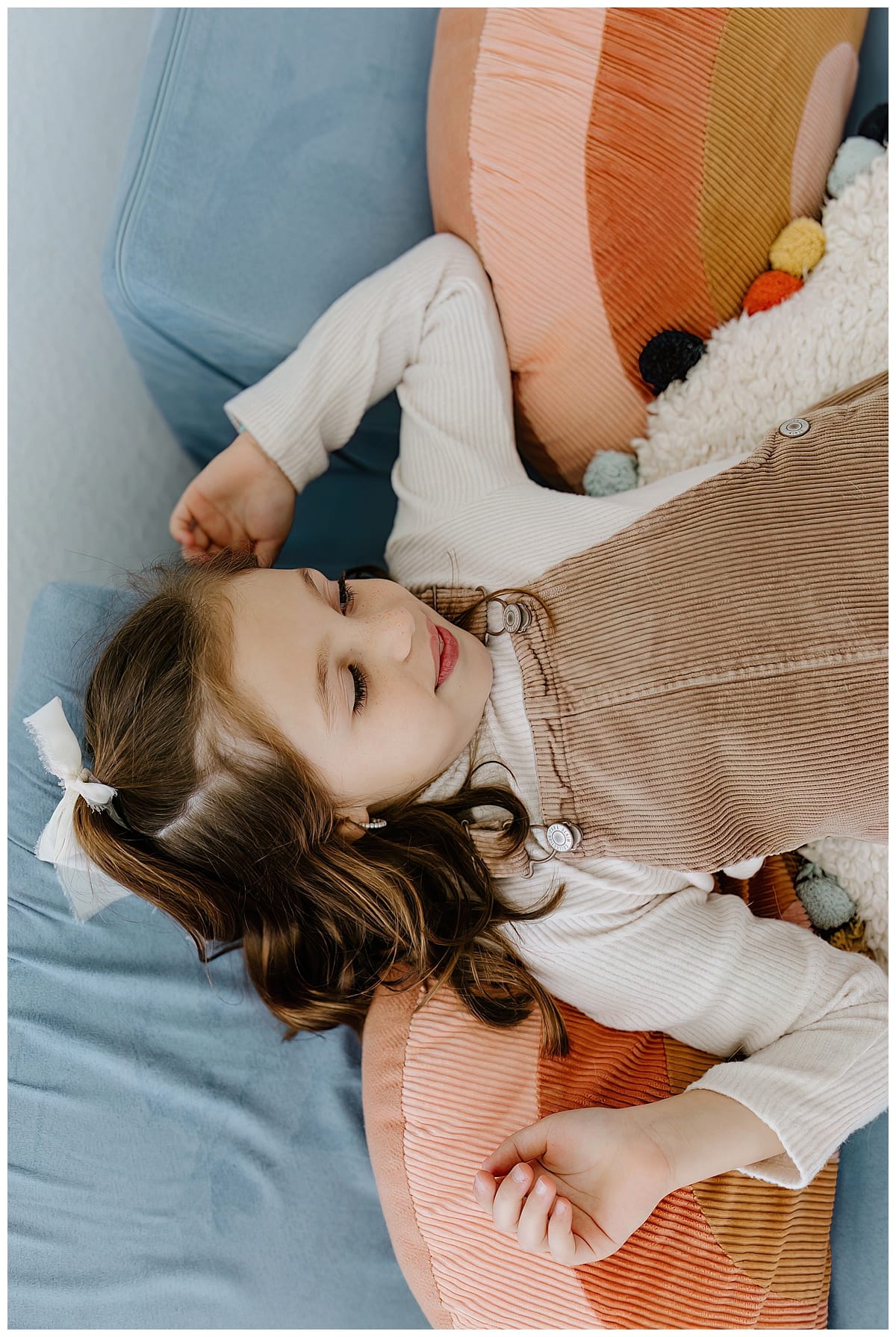 Young girl lays on the pillow for Our Adventuring Souls Photography